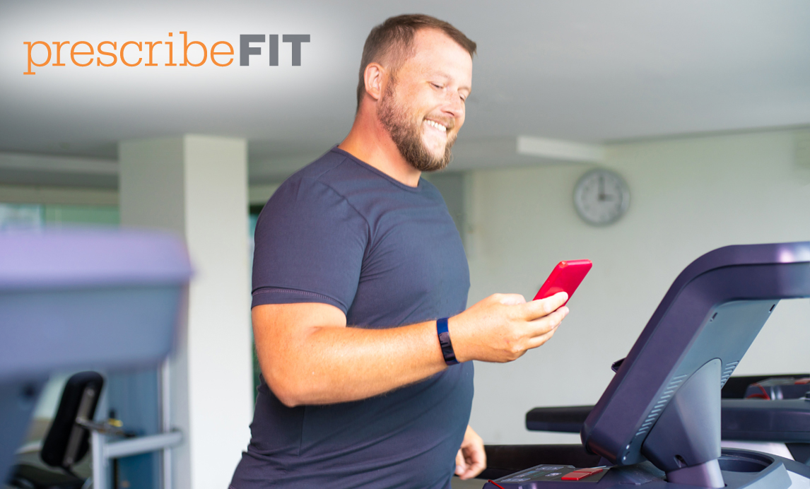 man on treadmill with phone